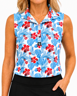 Aloha women’s sleeveless golf polo with red hibiscus flowers and blue tropical leaves