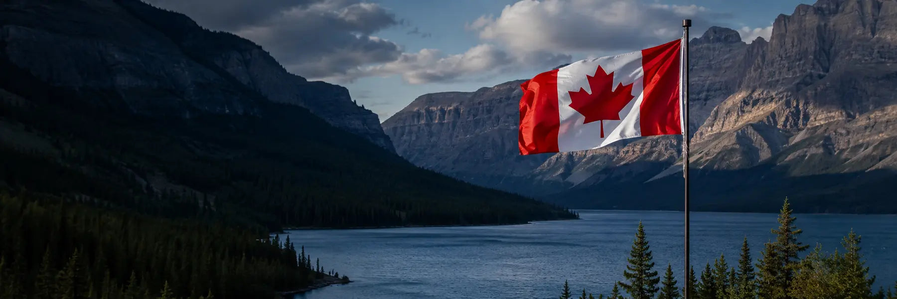 Canadian flag overlooking a mountain lake