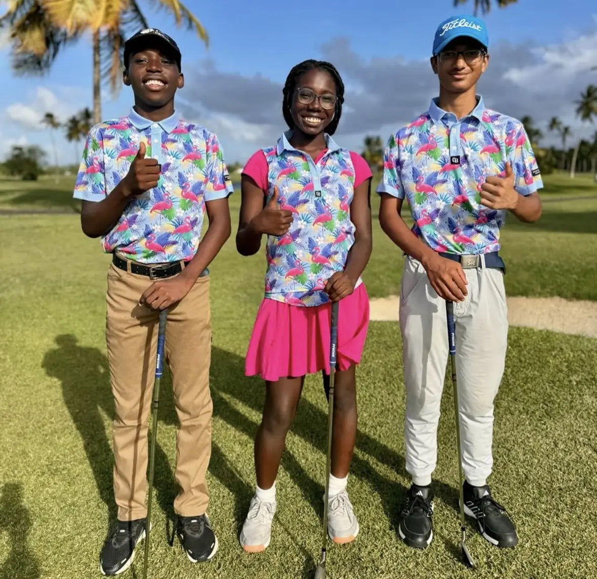 Junior golfers wearing Shop Out of Bounds polos through a golf access program